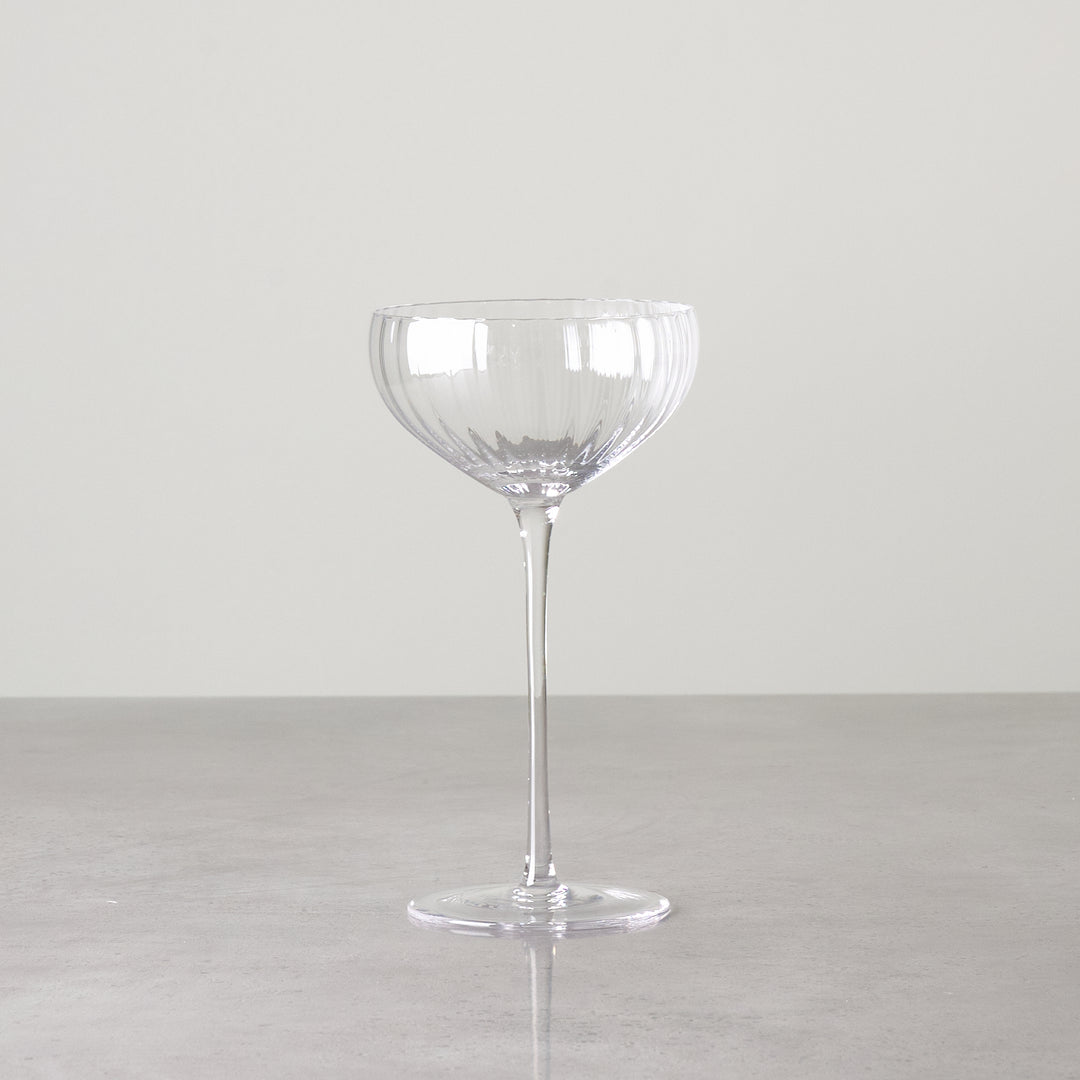 Clear ribbed coupe-style glass shown individually to highlight bowl shape and detailing