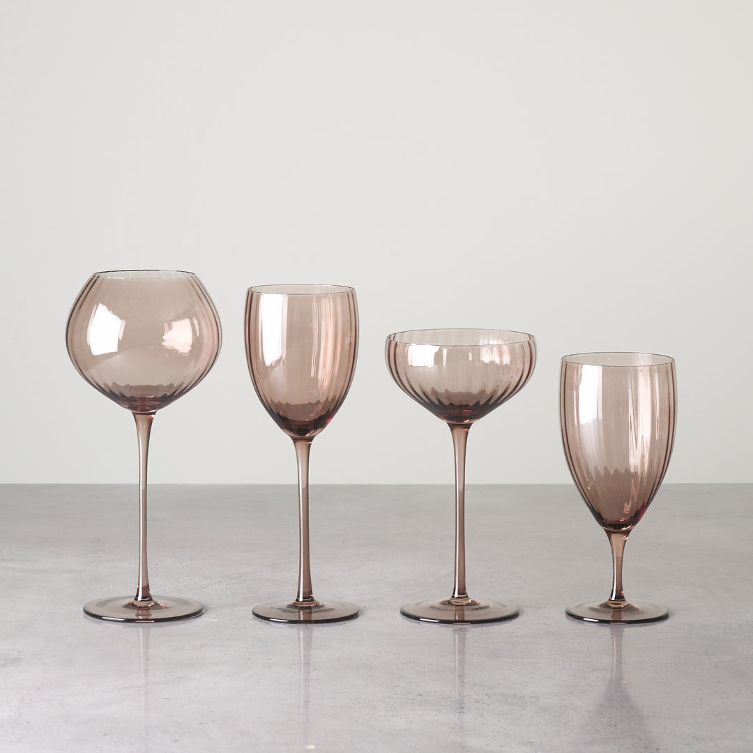 Brown-tinted glass stemware set with modern silhouette for event rentals