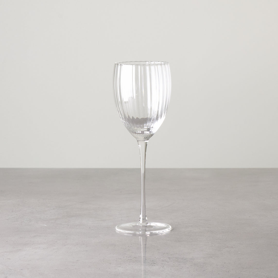 Clear ribbed white wine glass shown individually to highlight shape and detailing